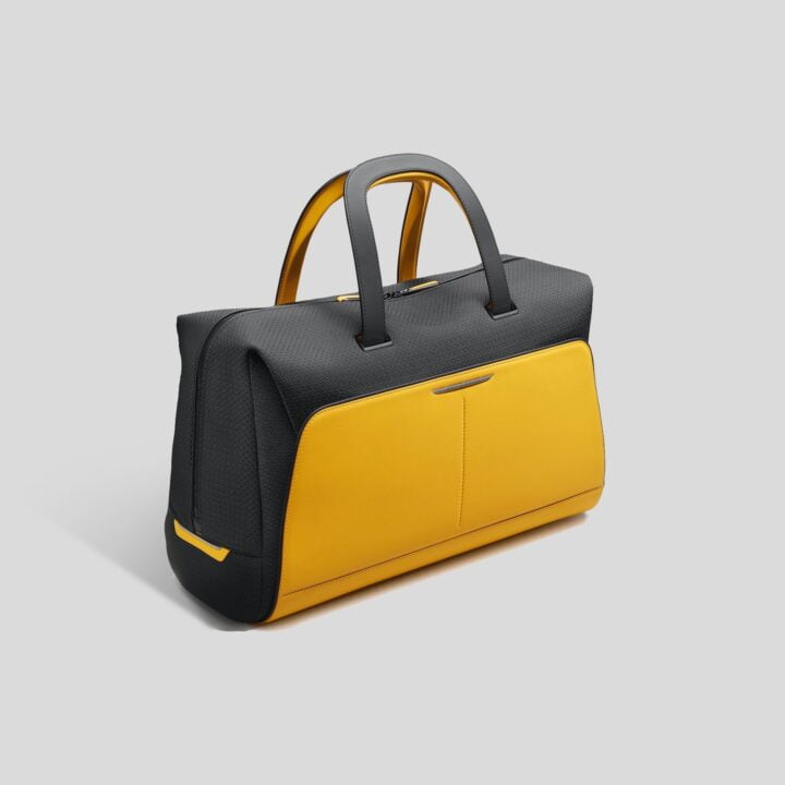 Black Badge Escapism Luggage Bold, 24hr Weekend Forge Yellow bag product image via Gerry Spahn at Rolls-Royce Motor Cars for use by 360 Magazine