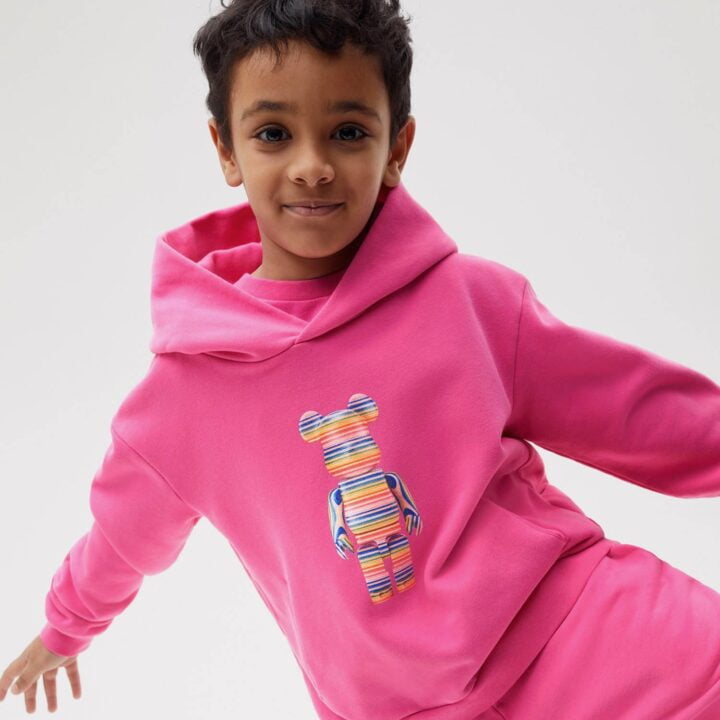 Pangaia x Haroshi Bearbrick Heavyweight Organic Cotton Hoodie Flamingo Pink Kids with MEDICOM TOY image via Leyla Ozden for use by 360 Magazine