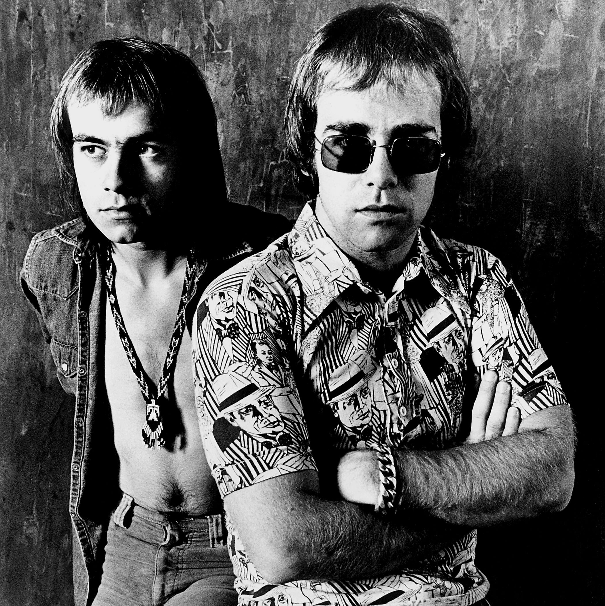 Elton John and Bernie Taupin pose for a portrait for a DJM records publicity shot, 1971 via 360 MAGAZINE