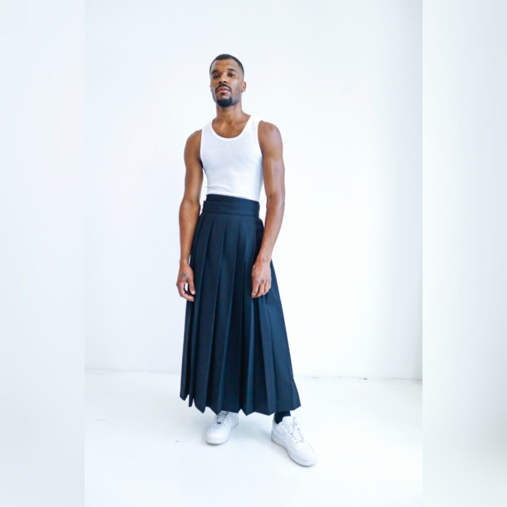 Terry Singh designs epic homeboy chic pleated dress for men at NYFW featured in 360 MAGAZINE