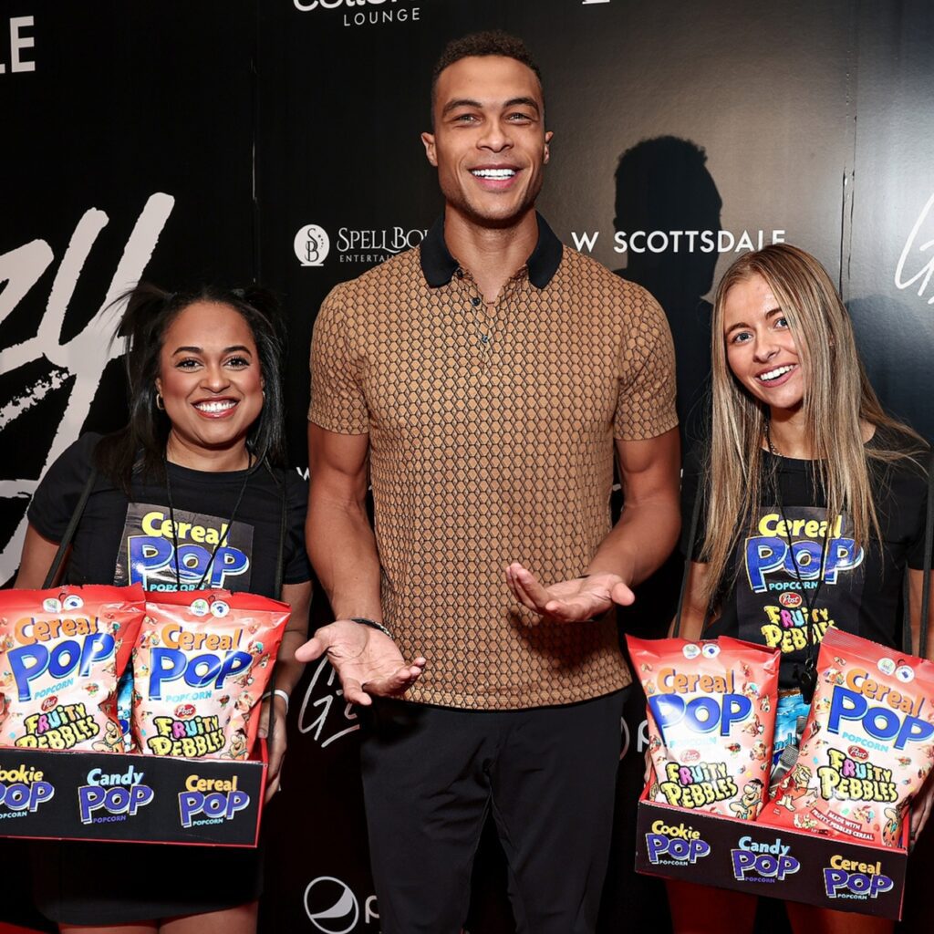 Dale Moss from The Bachelor on the carpet with the Cereal Pop promo girls before Cardi B's performance via 360 MAGAZINE.