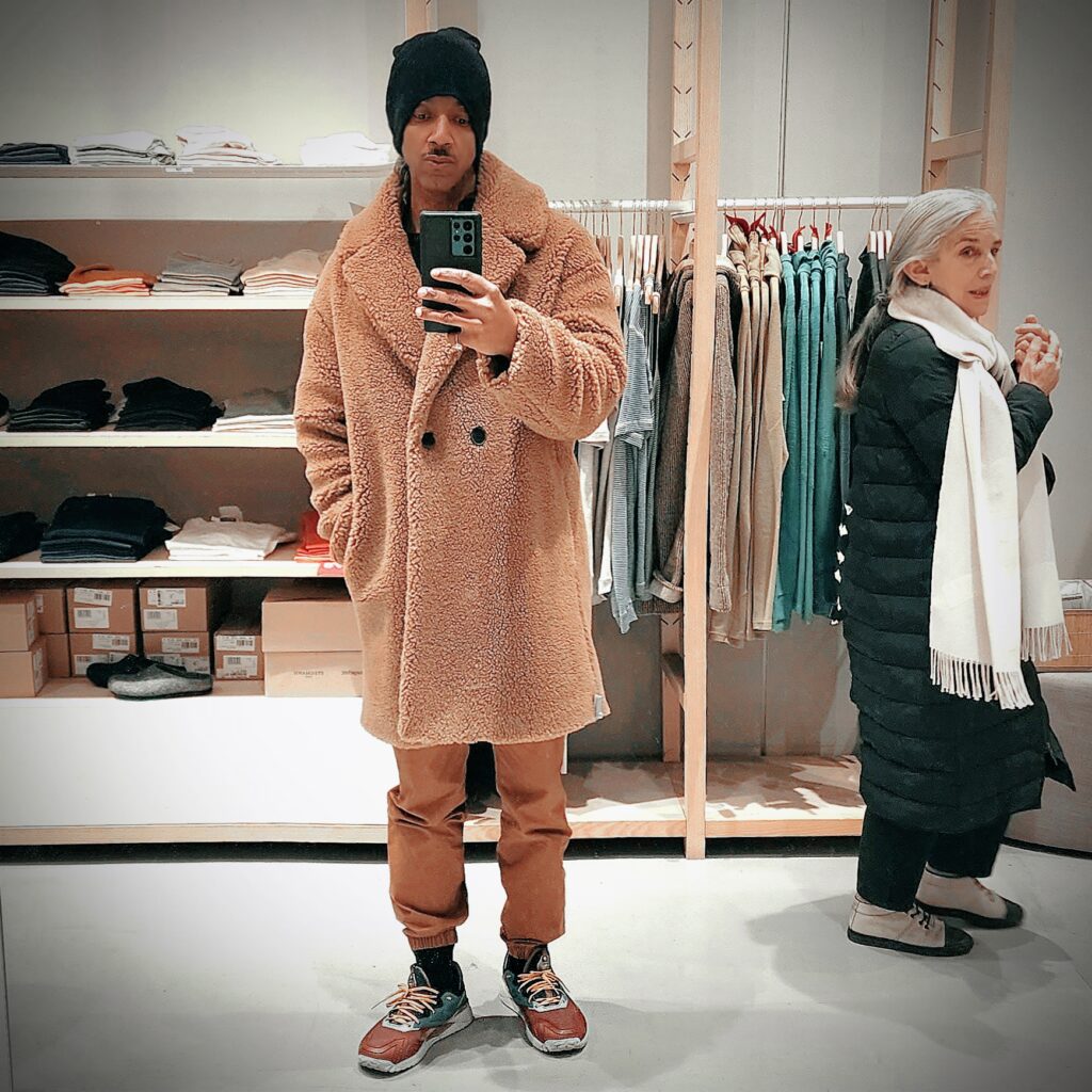 Vaughn Lowery, president of 360 MAGAZINE, tries on teddy coat with new wool with organic cotton and camel hair.