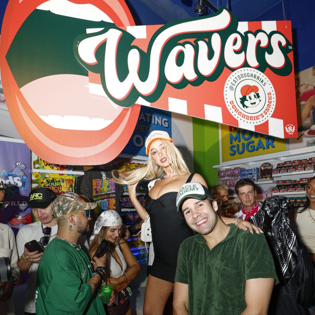 David Dobrik hosts Lollapalooza afterparty in celebration of the nationwide launch of Wavers, his pizza-inspired snack, at IT’SUGAR’s flagship store in Chicago, where he jumped in the DJ booth with DJ Nate Wyatt for an impromptu guest spin via 360 MAGAZINE.