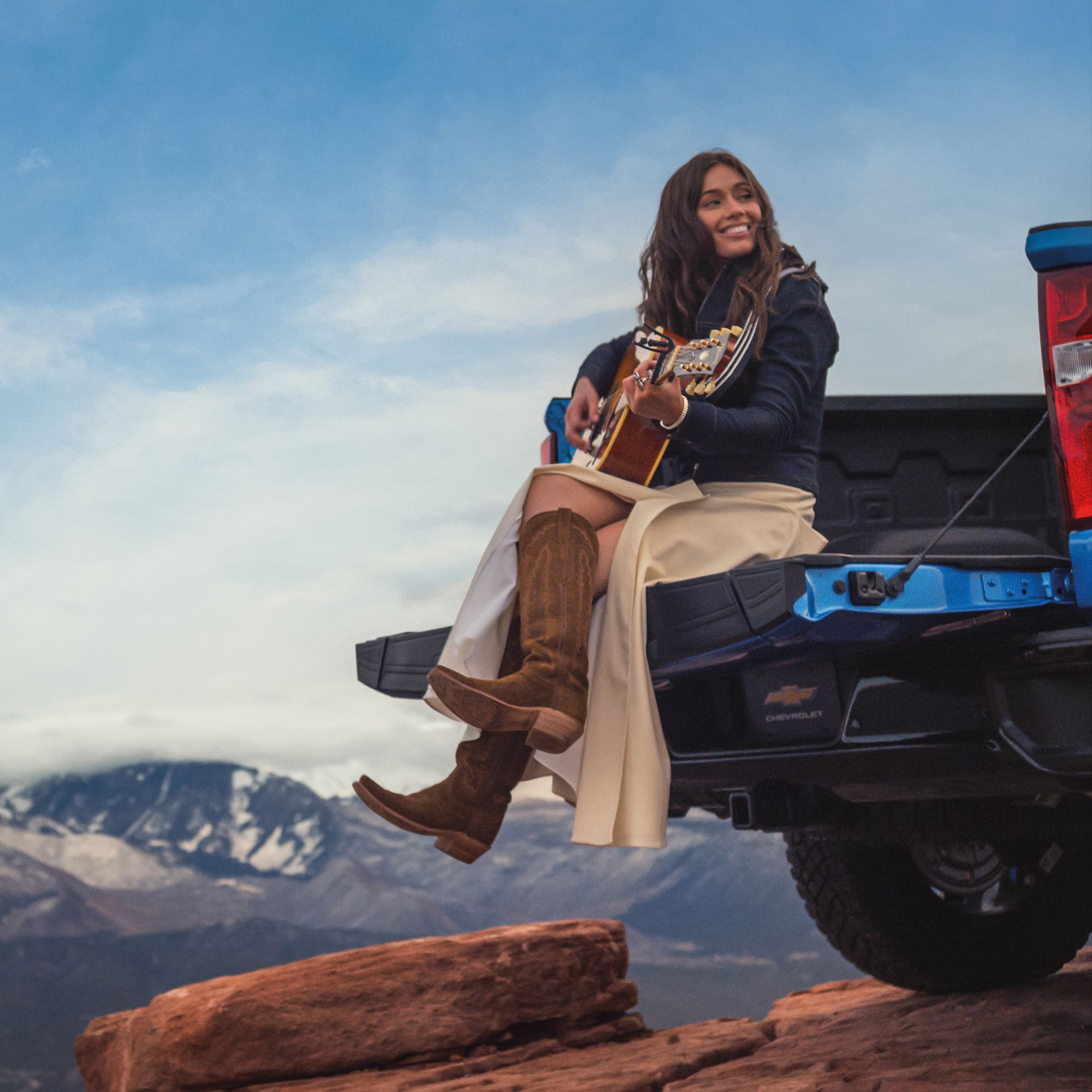 Brooke Lee sings from the tailgate of a 2026 Chevrolet Silverado ZR2 that has been airlifted to the top of Castle Rock in Utah via 360 MAGAZINE.
